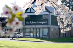 Photo of St John's Hospice building - it's painted white and surrounded by greenery..